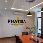 a room with a table and chairs and a yellow & black sign on a wall