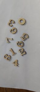 laser cut small plywood lettering for a wall clock crafting project