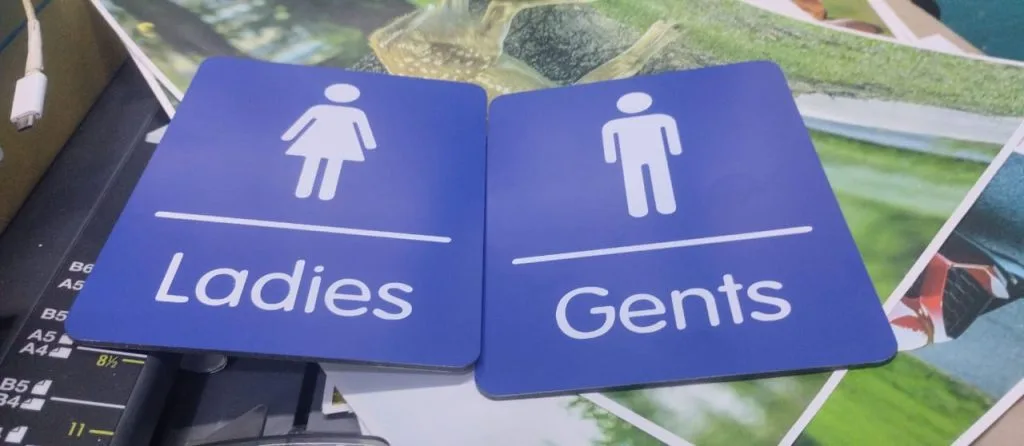 photo of ladies gents toilet signs on a table