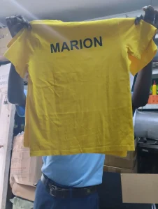 photo of a yellow school t-shirt printed with students name
